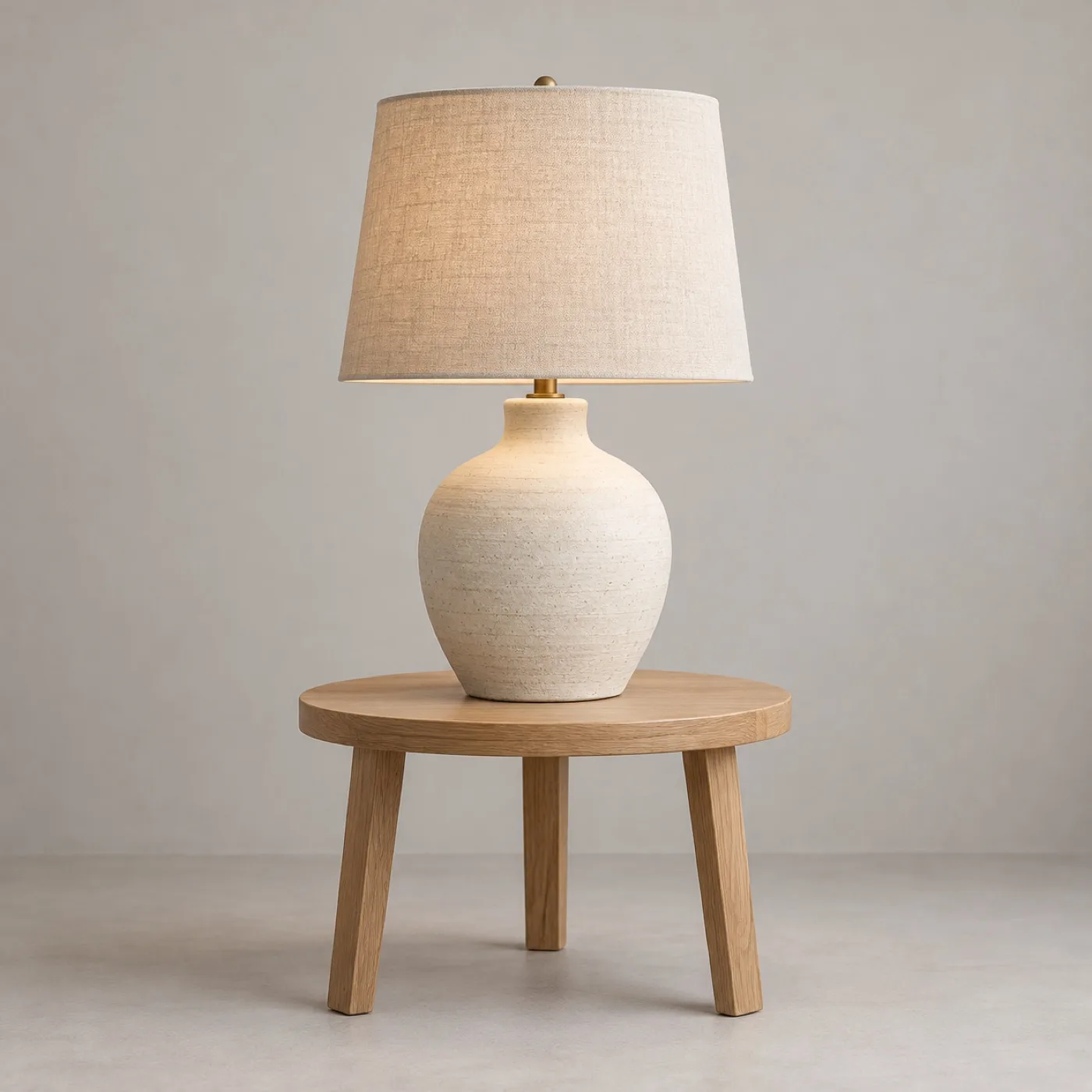 Before: ceramic lamp and oak side table against a pale neutral background