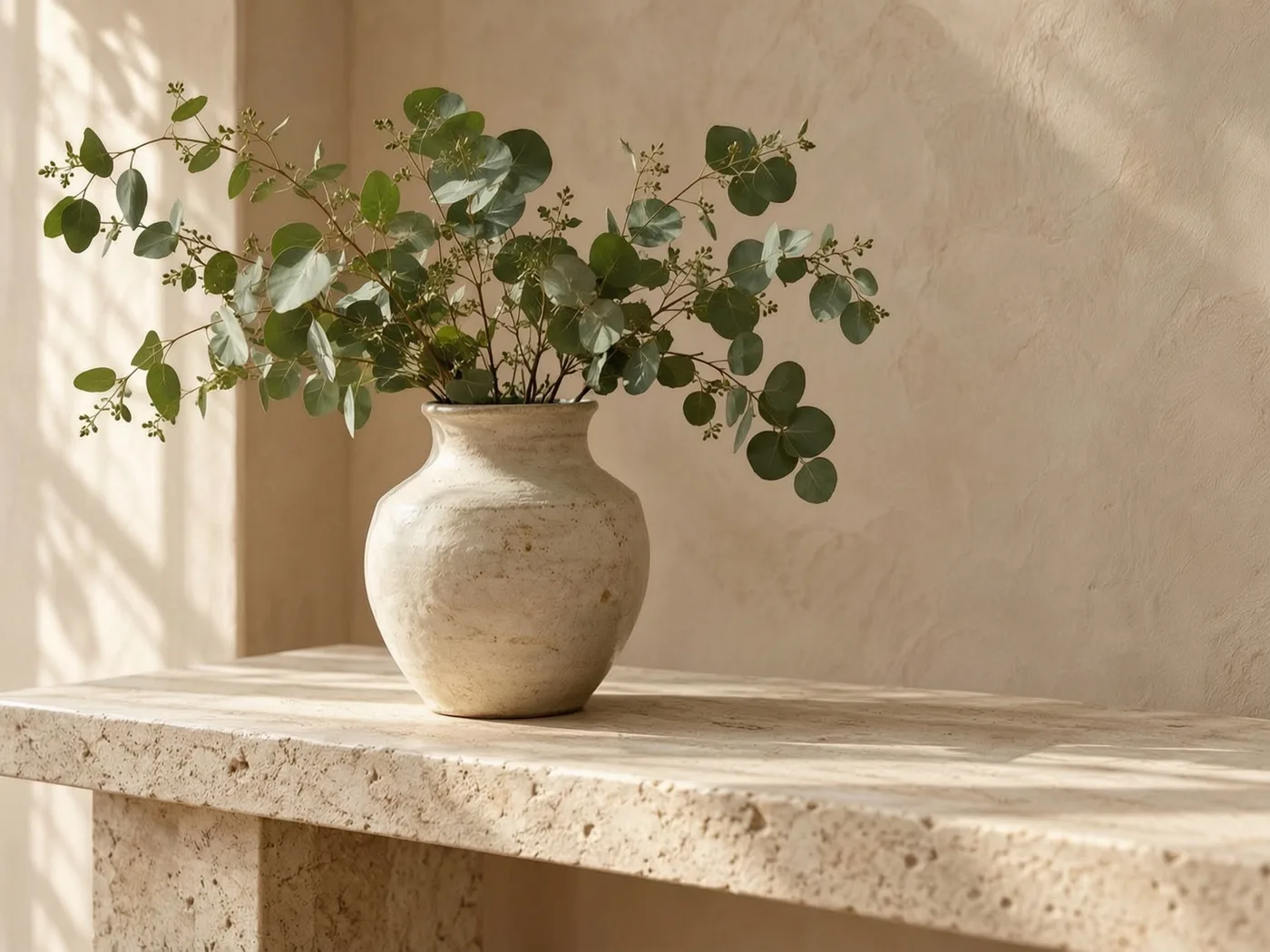 Vase on a limestone console after removing a book and brass dish